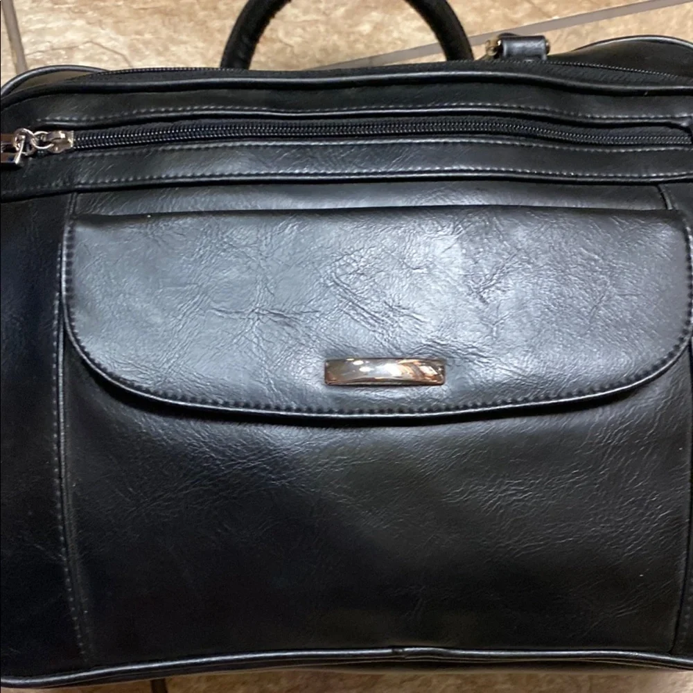 Black Duffel Bag with Structured Design and Smooth Vinyl Practical Utility